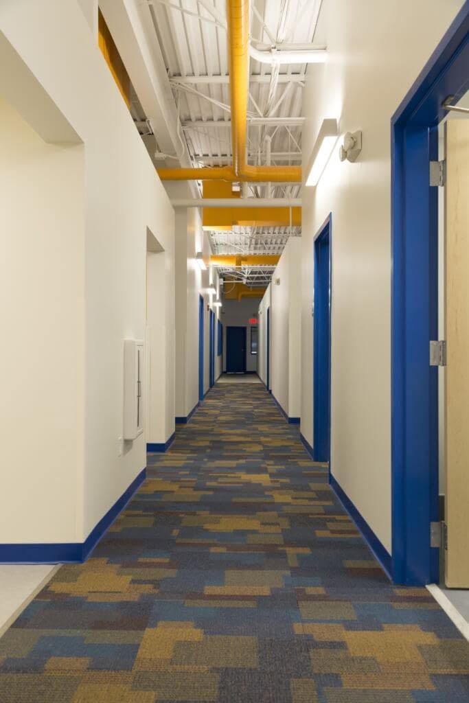 Office corridor Boys and Girls Club of Rochester NY bright colors exposed structure and exposed ductwork